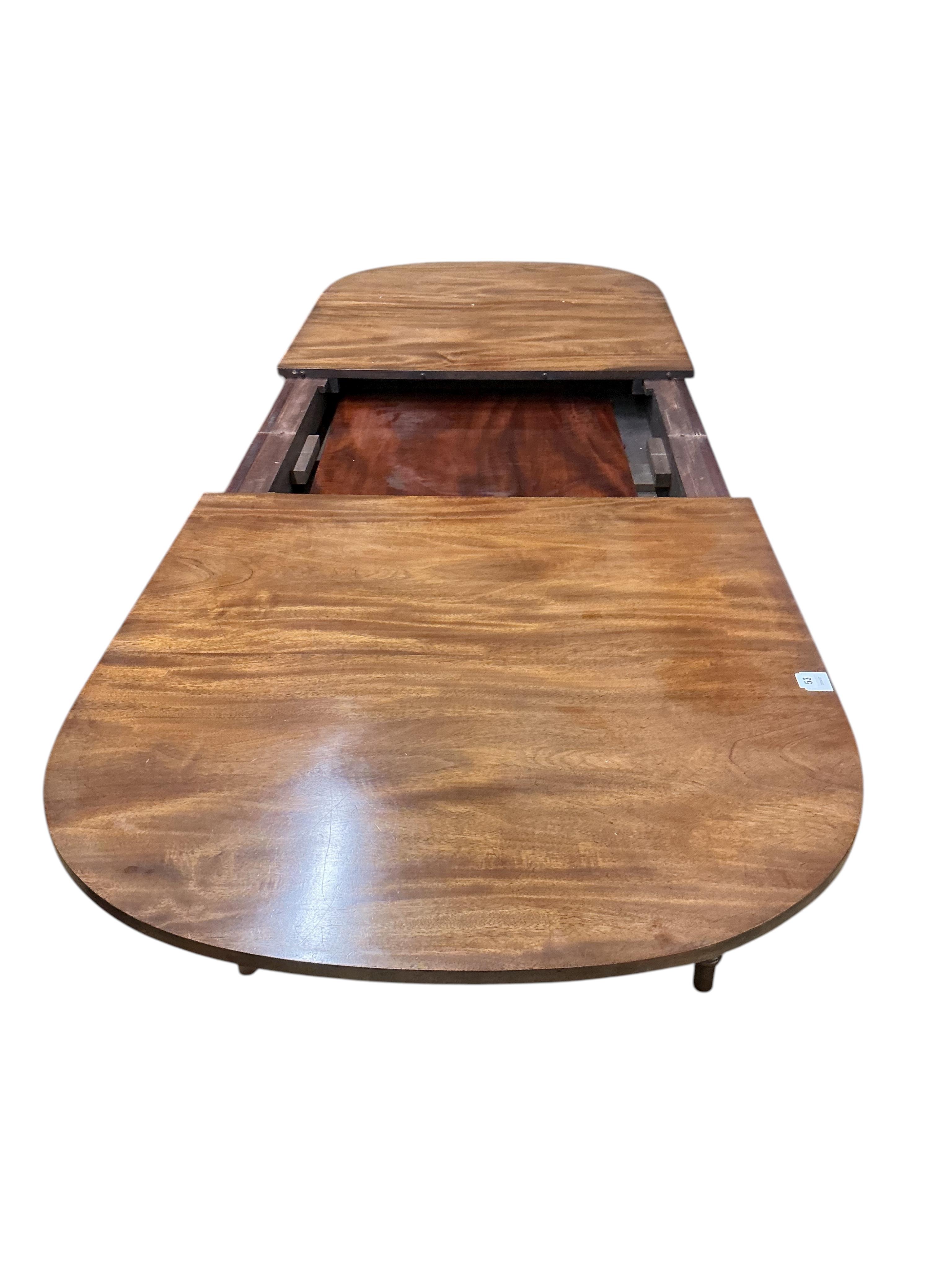A reproduction Sheraton style mahogany extending dining table, 260cm extended, one spare leaf, width 91cm, height 76cm